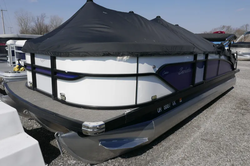 Slide: The Image of 2023 Barletta Cabrio 22UC pontoon boat with black cover, parked on gravel. - 14