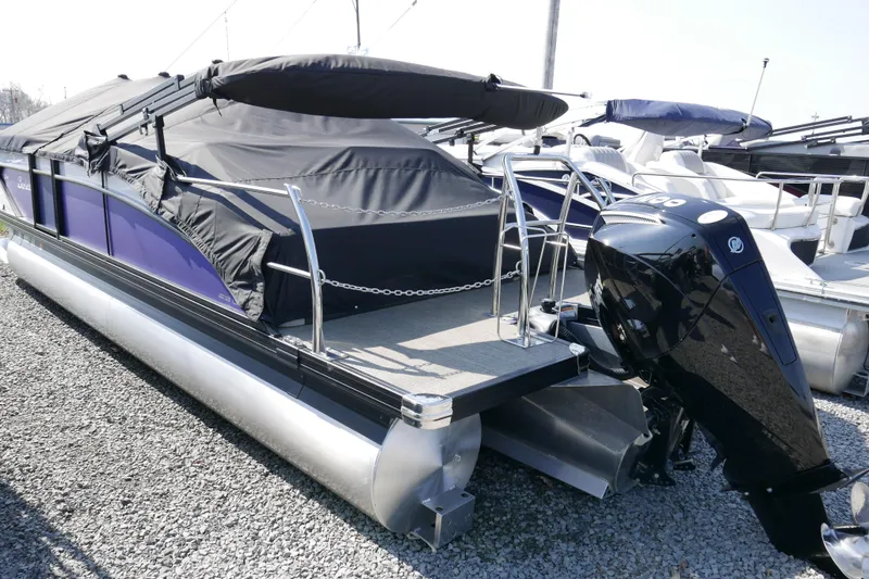 Slide: The Image of 2023 Barletta Cabrio 22UC pontoon boat with black canopy and powerful outboard motor. - 16