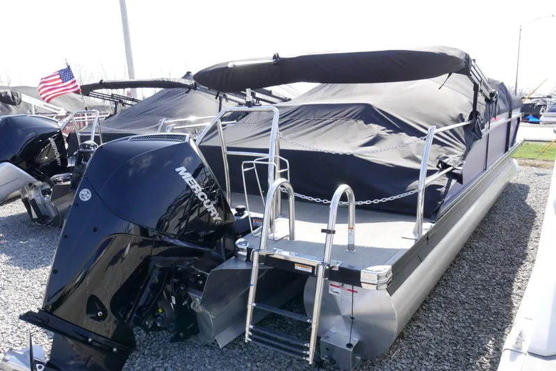 Slide: The Image of 2023 Barletta Cabrio 22UC pontoon boat with Mercury engine, covered and docked. - 17