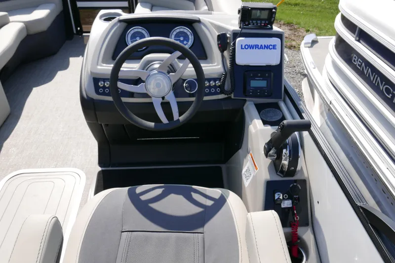 Slide: The Image of 2023 Barletta Cabrio 22UC boat dashboard with steering wheel and navigation equipment. - 9