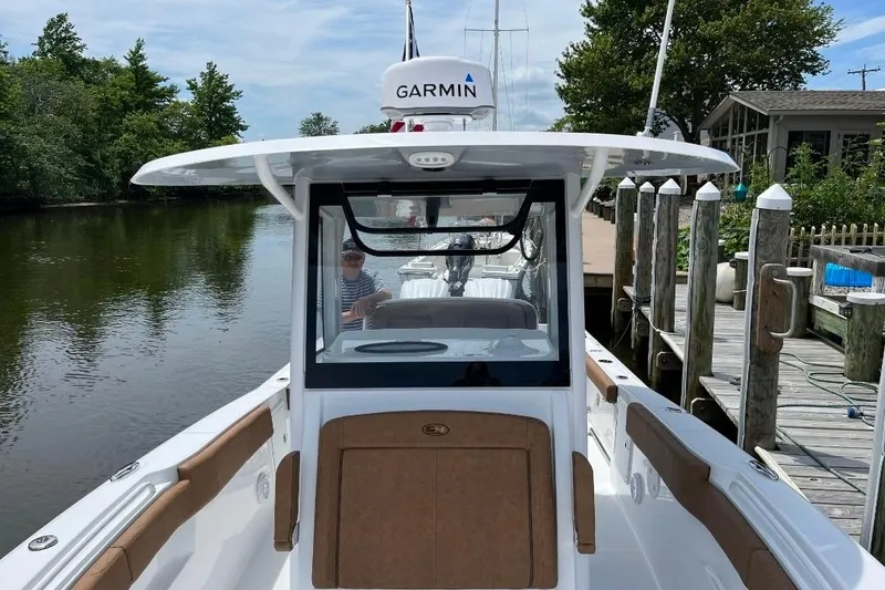 Slide: The Image of 2022 Sea Hunt Gamefish 30 boat docked, featuring forward seating and Garmin equipment. - 4