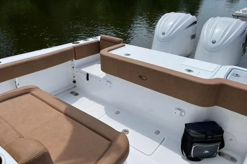 Slide: The Image of 2022 Sea Hunt Gamefish 30 boat with forward seating and twin engines on calm water. - 6