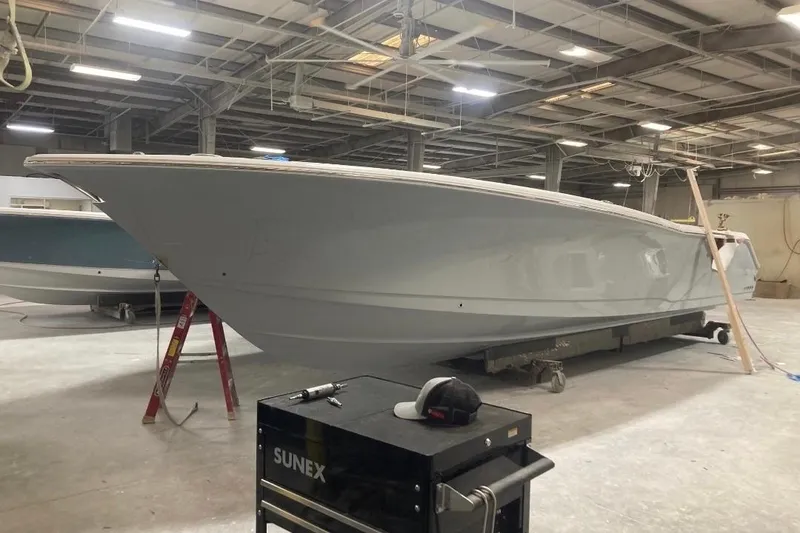 Slide: The Image of 2022 Sea Hunt Gamefish 30 boat in a warehouse, under construction. - 9