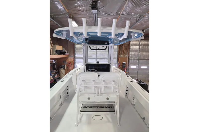 Slide: The Image of 2026 Sportsman Heritage 231 Center Console boat interior with seating and rod holders. - 10