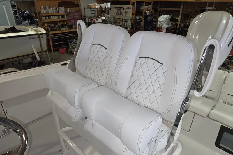 Slide: The Image of 2026 Sportsman Heritage 231 Center Console boat with white cushioned seating. - 12