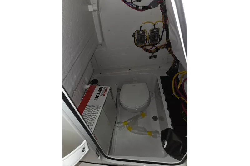 Slide: The Image of Interior of 2026 Sportsman Heritage 231 Center Console boat, featuring storage and wiring. - 13