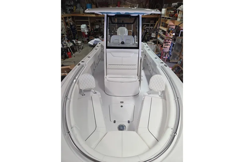 Slide: The Image of 2026 Sportsman Heritage 231 Center Console boat interior with white seating and modern design. - 14