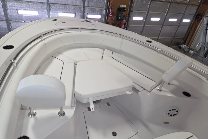 Slide: The Image of 2026 Sportsman Heritage 231 Center Console boat interior with white seating and storage. - 15
