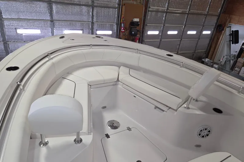 Slide: The Image of 2026 Sportsman Heritage 231 Center Console boat interior with white seating and stainless steel railings. - 16