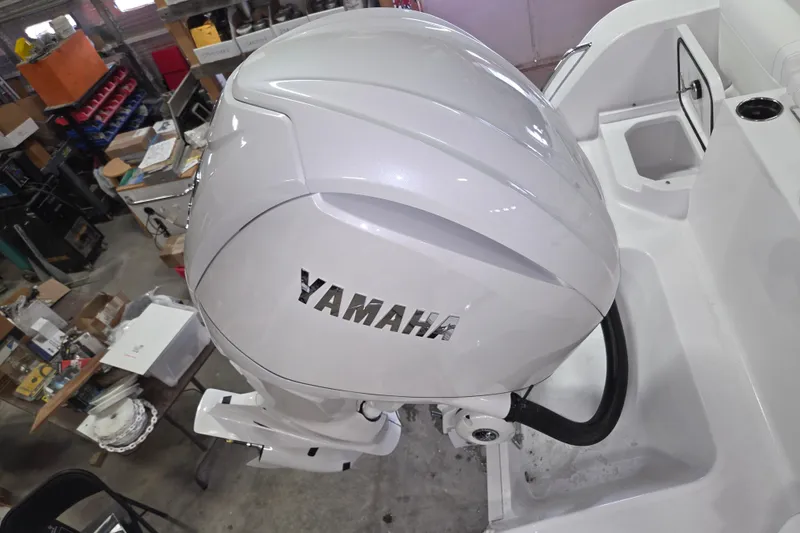 Slide: The Image of 2026 Sportsman Heritage 231 Center Console with Yamaha outboard engine in a workshop setting. - 17