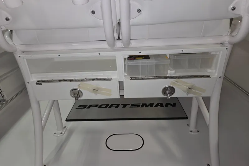 Slide: The Image of 2026 Sportsman Heritage 231 Center Console storage compartments with tackle boxes and secure locks. - 2