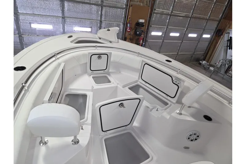 Slide: The Image of 2026 Sportsman Heritage 231 Center Console boat interior with storage compartments. - 22