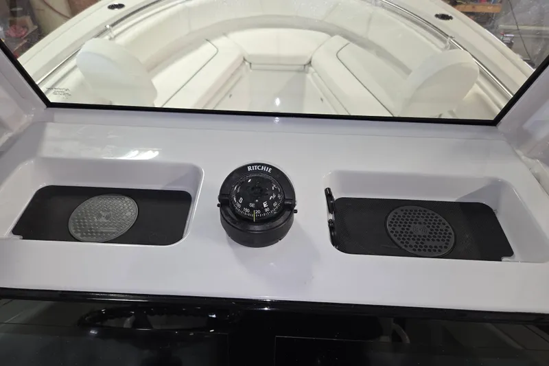 Slide: The Image of 2026 Sportsman Heritage 231 Center Console dashboard with compass and storage compartments. - 7