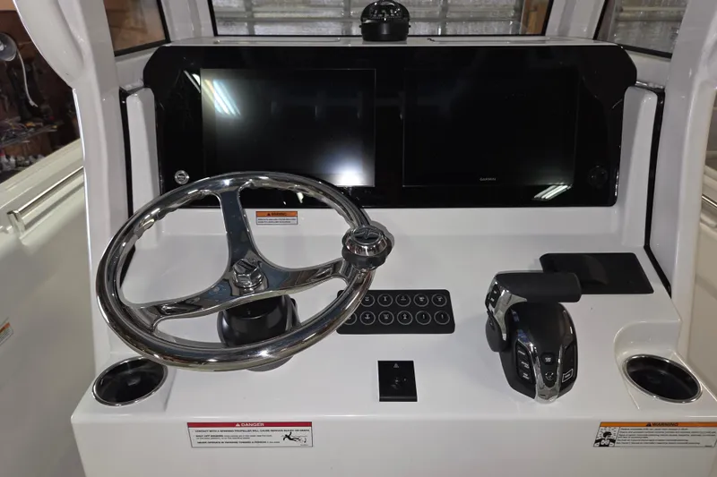 Slide: The Image of Steering console of 2026 Sportsman Heritage 231 Center Console boat with modern controls. - 9