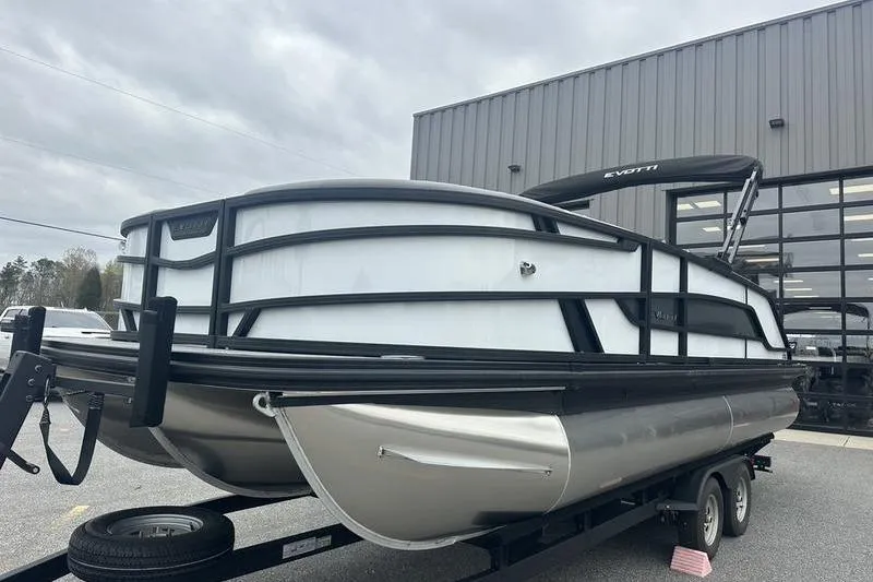 The Image of 2026 Evotti 521QL pontoon boat on trailer, parked outside a building. - 1