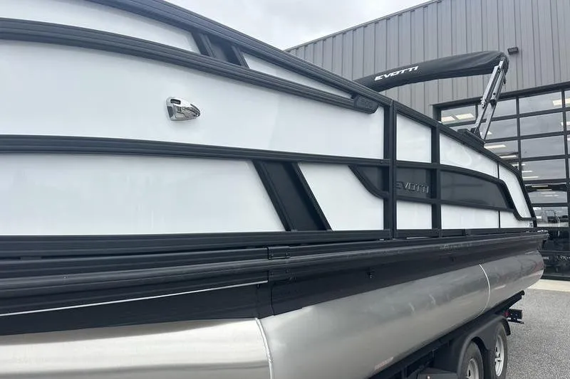 Slide: The Image of 2026 Evotti 521QL pontoon boat with sleek design, parked outside a building. - 10