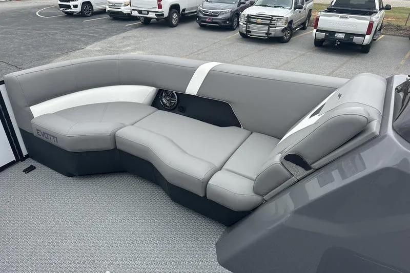Slide: The Image of Luxurious gray seating on 2026 Evotti 521QL boat, parked with vehicles in background. - 11