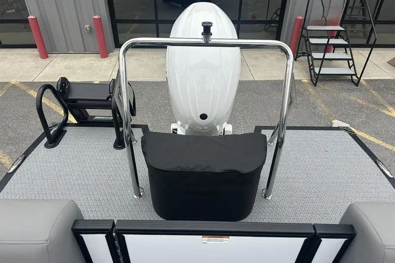 Slide: The Image of Evotti 521QL 2026 boat deck with motor and seating, parked outdoors. - 17