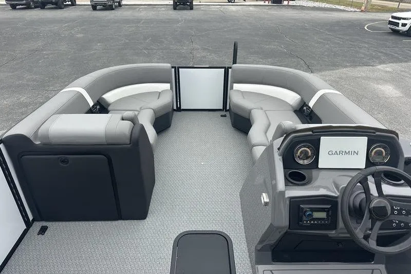 Slide: The Image of 2026 Evotti 521QL boat interior with gray seating and Garmin navigation system. - 21