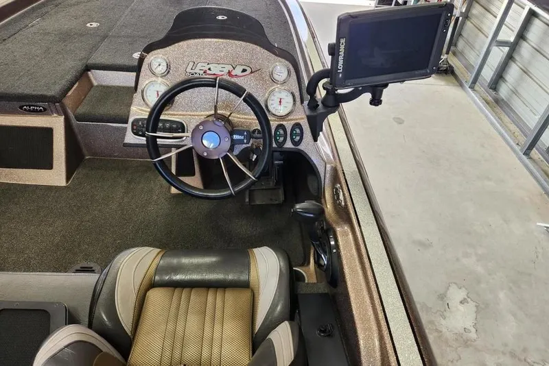 Slide: The Image of 2014 Legend 199 Alpha DC boat dashboard with steering wheel and navigation display. - 6