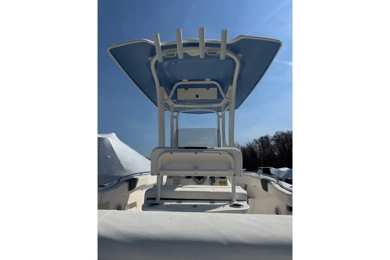 Slide: The Image of 2023 Robalo R222 Center Console boat with T-top under clear blue sky. - 6