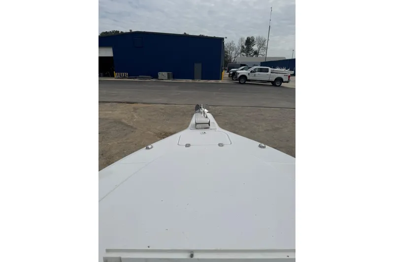 Slide: The Image of Bow view of a 1998 Donzi 30 ZF Daytona boat in a parking area. - 10