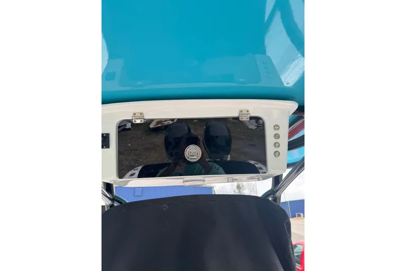 Slide: The Image of 1998 Donzi 30 ZF Daytona boat console with blue canopy and reflective surface. - 13