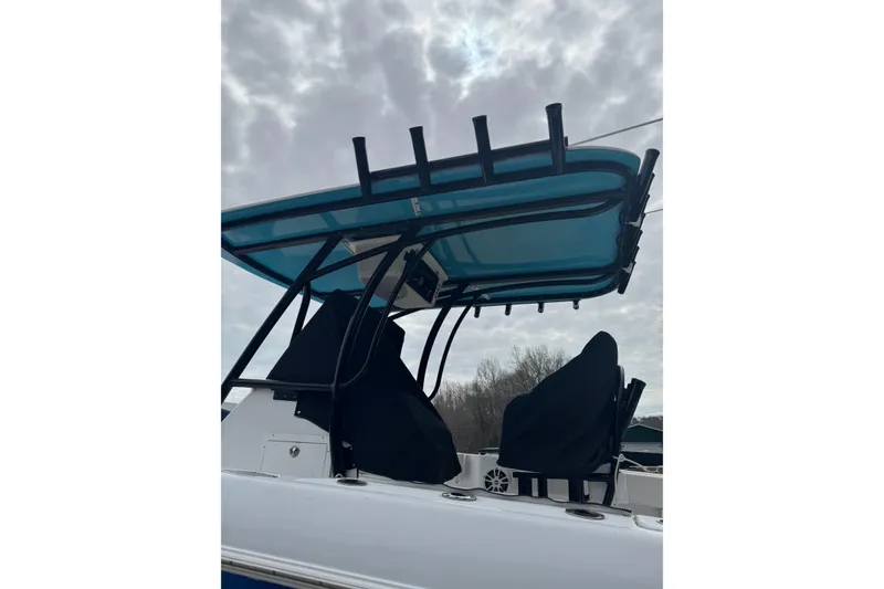 Slide: The Image of 1998 Donzi 30 ZF Daytona boat with covered seats and blue canopy. - 4