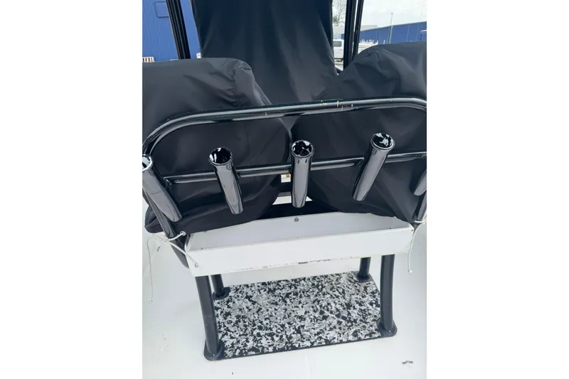 Slide: The Image of 1998 Donzi 30 ZF Daytona boat seat with rod holders and protective covers. - 6