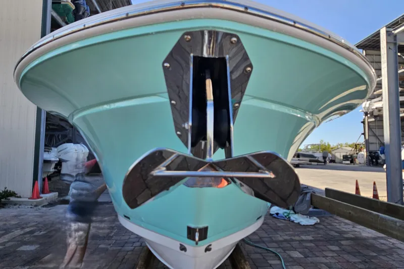 Slide: The Image of 2022 Blackfin 272 CC boat with teal hull, docked outdoors. - 11