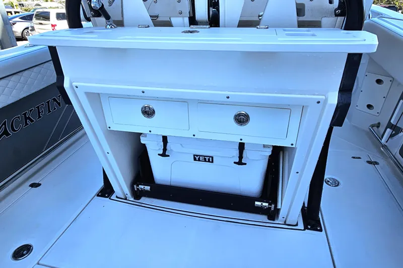 Slide: The Image of 2022 Blackfin 272 CC boat interior with storage drawers and Yeti cooler. - 14