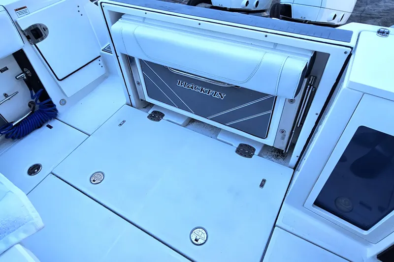 Slide: The Image of 2022 Blackfin 272 CC boat deck with storage compartments and seating. - 17