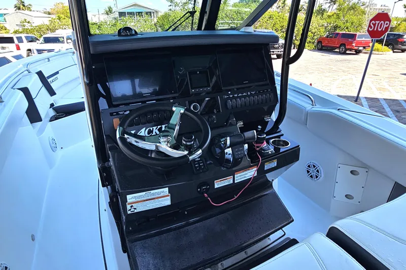 Slide: The Image of 2022 Blackfin 272 CC boat dashboard with steering wheel and controls. - 19