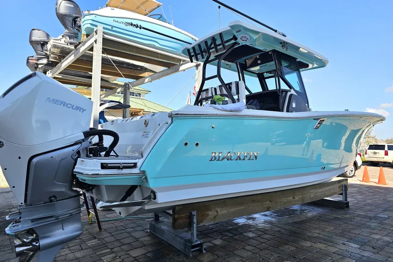 Slide: The Image of 2022 Blackfin 272 CC boat with Mercury engine on display. - 2