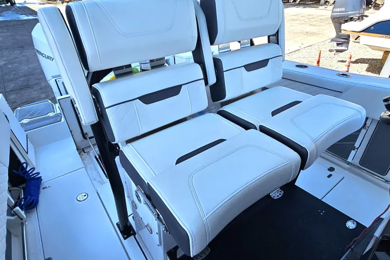 Slide: The Image of 2022 Blackfin 272 CC boat seating with white upholstery and adjustable backrests. - 21