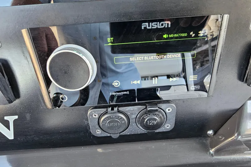 Slide: The Image of 2022 Blackfin 272 CC boat dashboard with Fusion audio system and Bluetooth connectivity. - 25