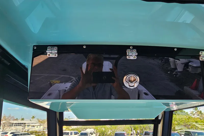 Slide: The Image of 2022 Blackfin 272 CC boat interior with reflective surface and visible hardware. - 27