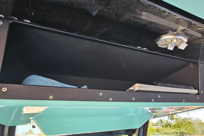 Slide: The Image of Storage compartment in a 2022 Blackfin 272 CC boat, featuring a light and blue cloth. - 28