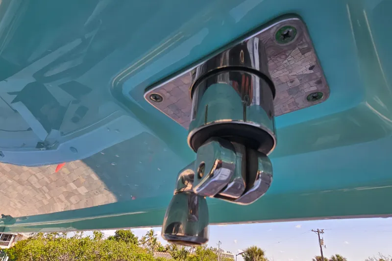 Slide: The Image of Close-up of a 2022 Blackfin 272 CC boat's chrome fitting against a blue hull. - 29