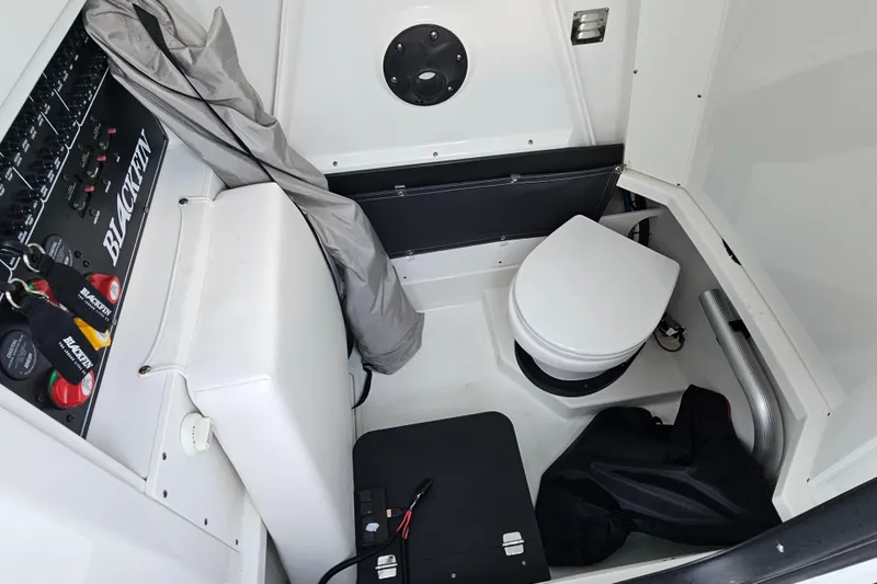 Slide: The Image of 2022 Blackfin 272 CC boat interior with toilet and control panel. - 30