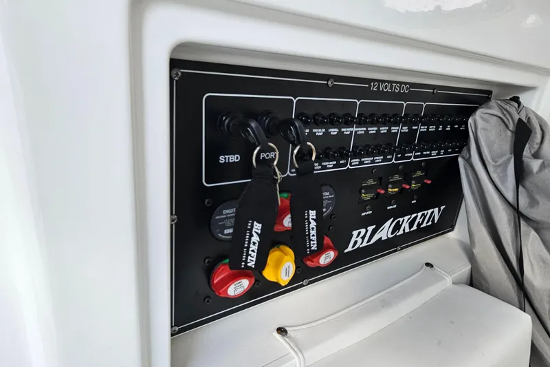 Slide: The Image of Control panel of 2022 Blackfin 272 CC boat with labeled switches and keys. - 31