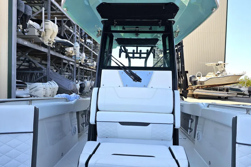 Slide: The Image of 2022 Blackfin 272 CC boat interior with white seating and storage racks in background. - 39