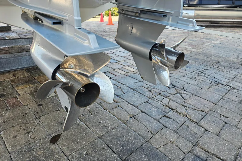 Slide: The Image of Dual propellers of a 2022 Blackfin 272 CC boat on a paved surface. - 4