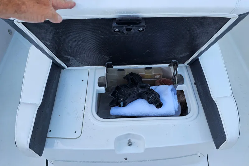 Slide: The Image of Open storage compartment on 2022 Blackfin 272 CC boat with mechanical parts inside. - 41