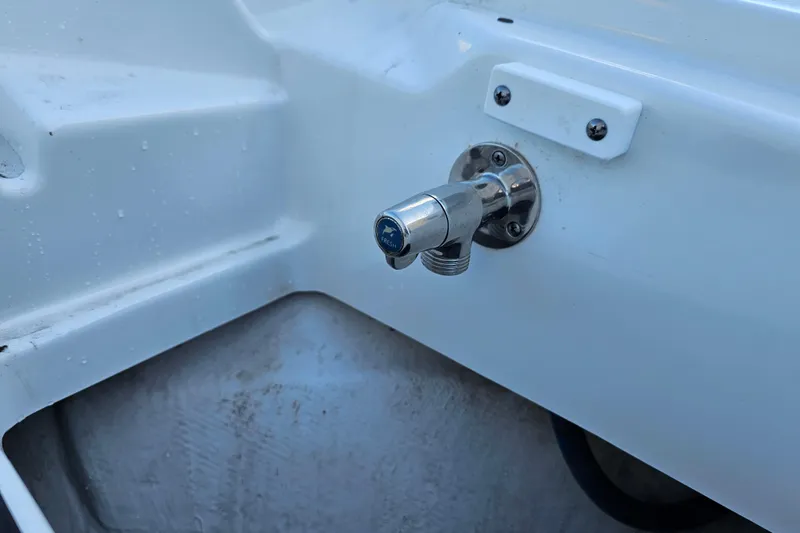 Slide: The Image of Close-up of a 2022 Blackfin 272 CC boat's fresh water outlet. - 43