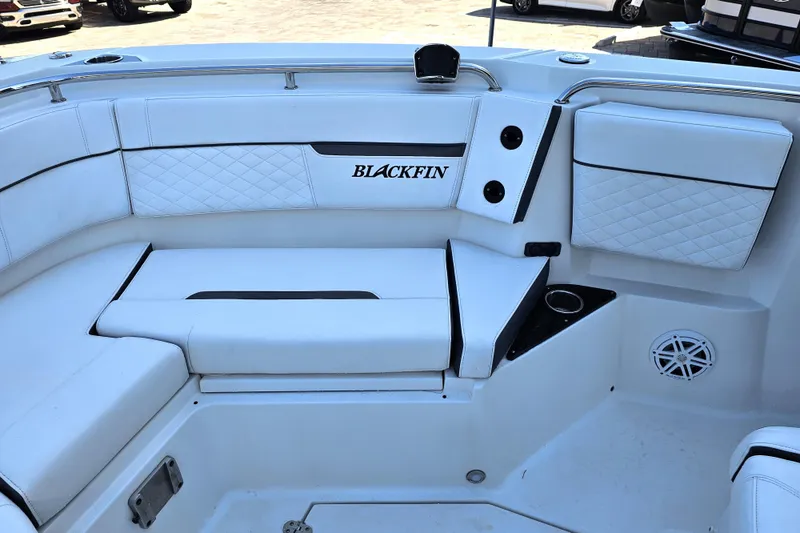 Slide: The Image of 2022 Blackfin 272 CC boat interior with white cushioned seating and cup holders. - 44