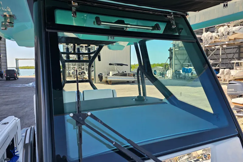Slide: The Image of 2022 Blackfin 272 CC boat windshield and wiper in a marina setting. - 46