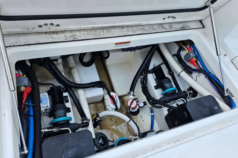 Slide: The Image of 2022 Blackfin 272 CC boat engine compartment with visible wiring and components. - 49