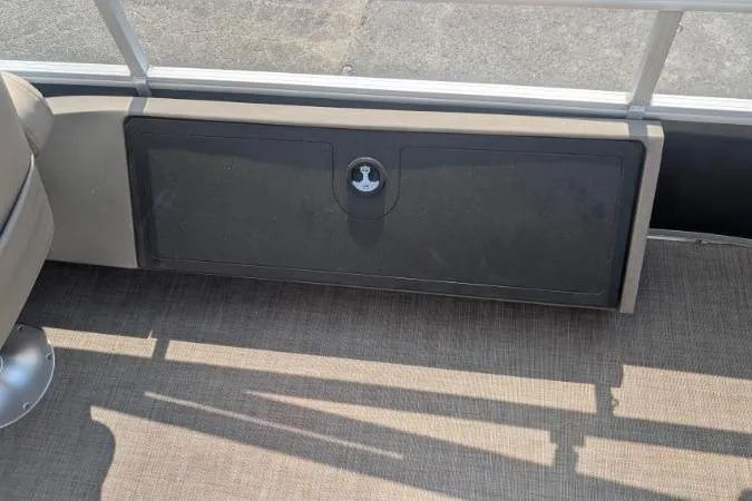 Slide: The Image of 2022 Sun Tracker SportFish 22 XP3 boat interior with storage compartment. - 10