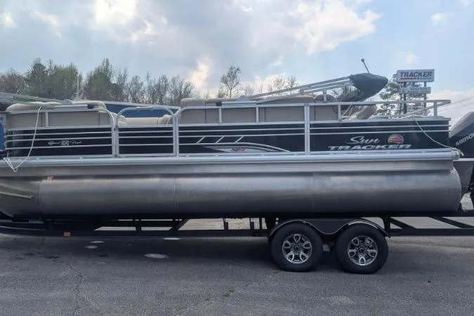 Slide: The Image of 2022 Sun Tracker SportFish 22 XP3 pontoon boat on trailer, parked outdoors. - 11